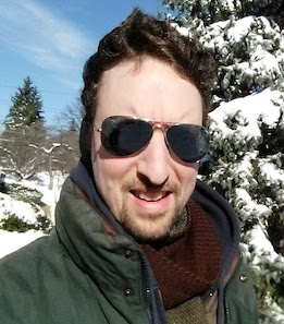 John shoveling snow on a bright January day